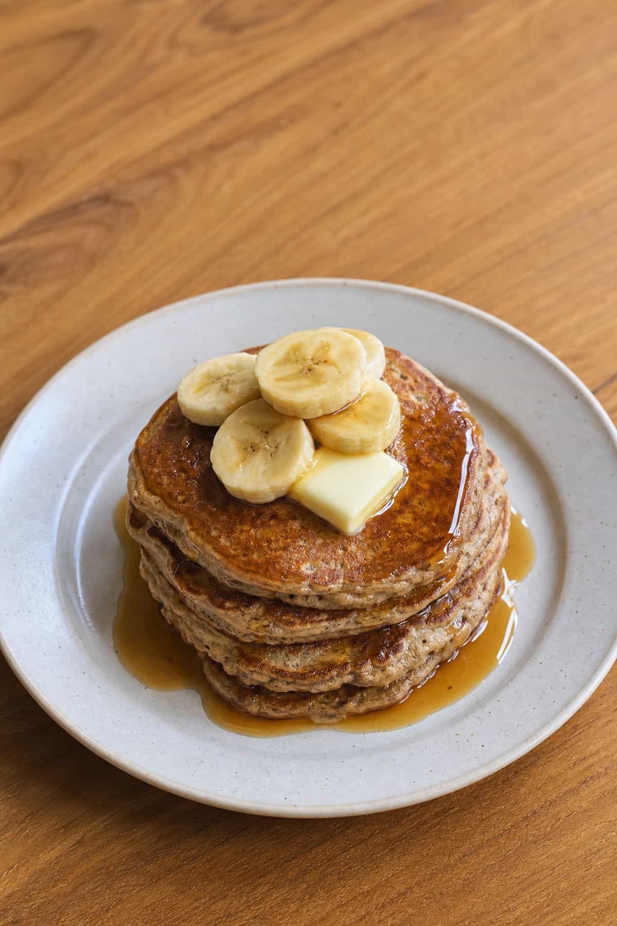Banana Buckwheat Pancakes Recipe (Fluffy, Gluten-Free, One Bowl) Stack of banana buckwheat pancakes with butter maple syrup and banana slices