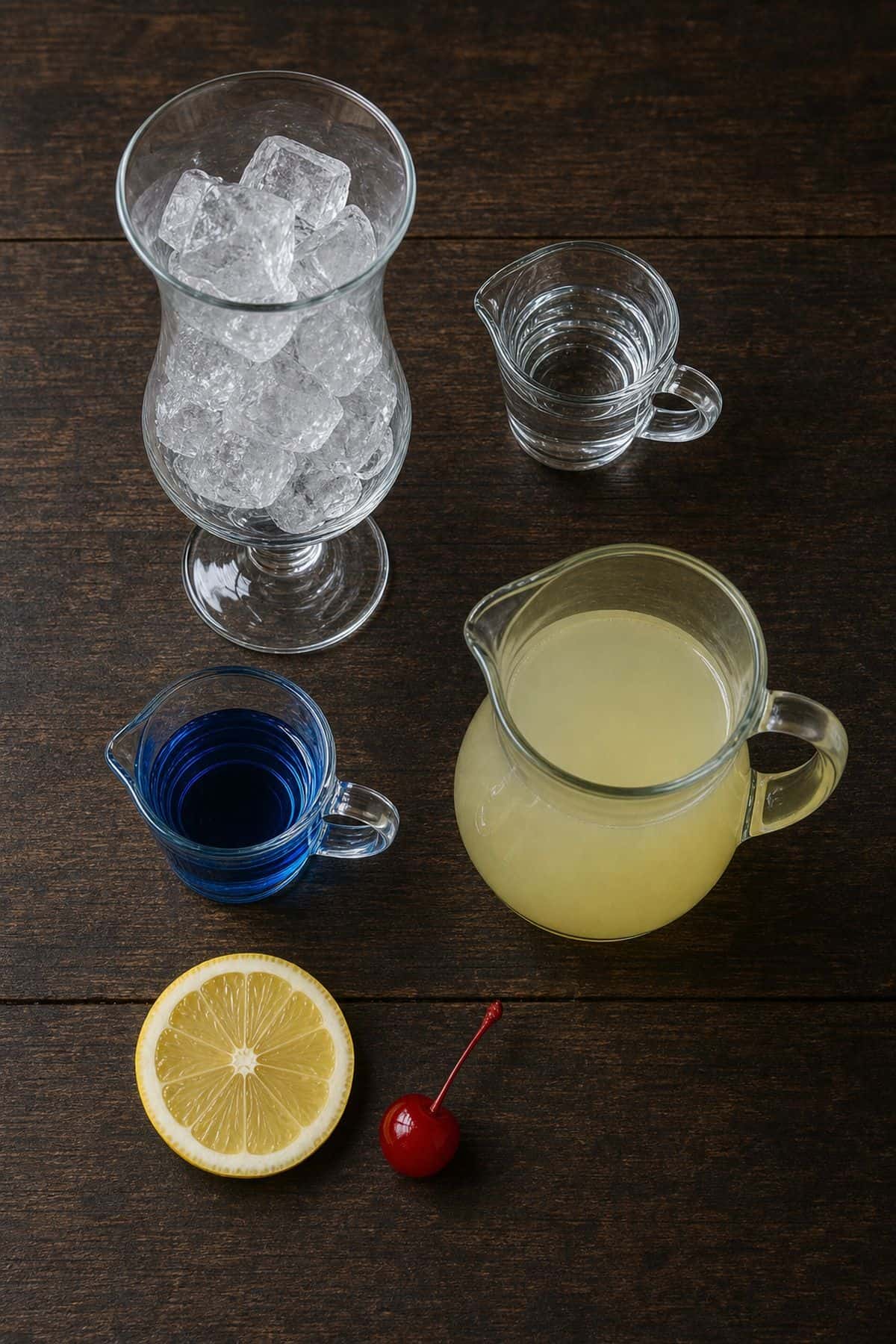 Blue Lagoon cocktail ingredients with vodka blue curacao lemonade ice lemon and cherry