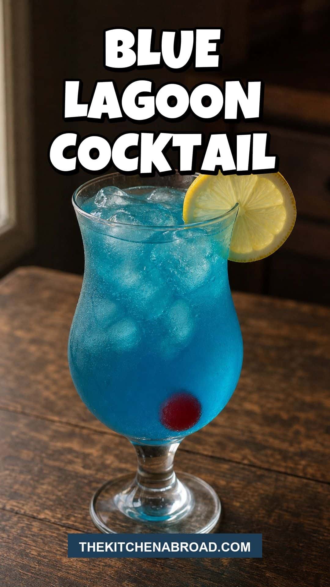 Blue Lagoon cocktail in a hurricane glass with lemon and cherry