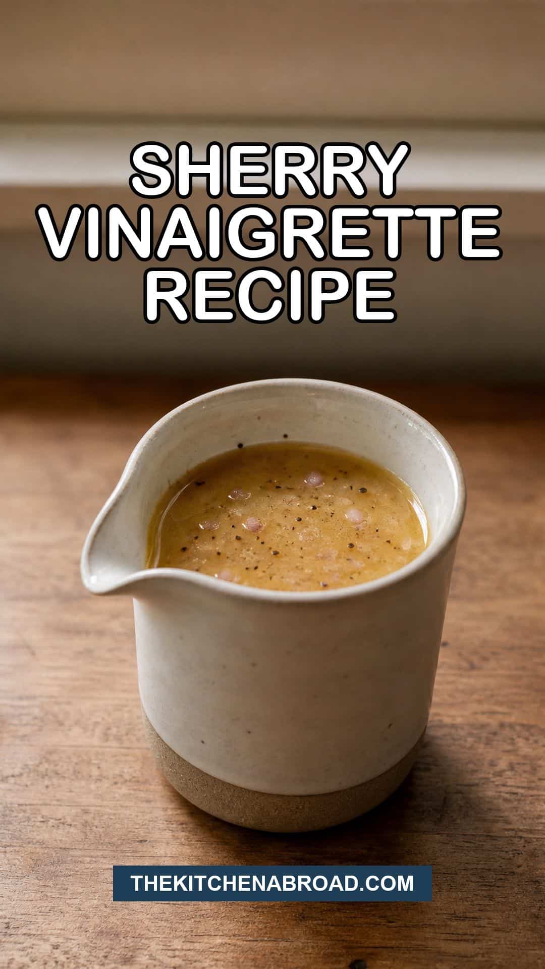 Pinterest pin for sherry vinaigrette recipe with a ceramic pitcher of homemade dressing