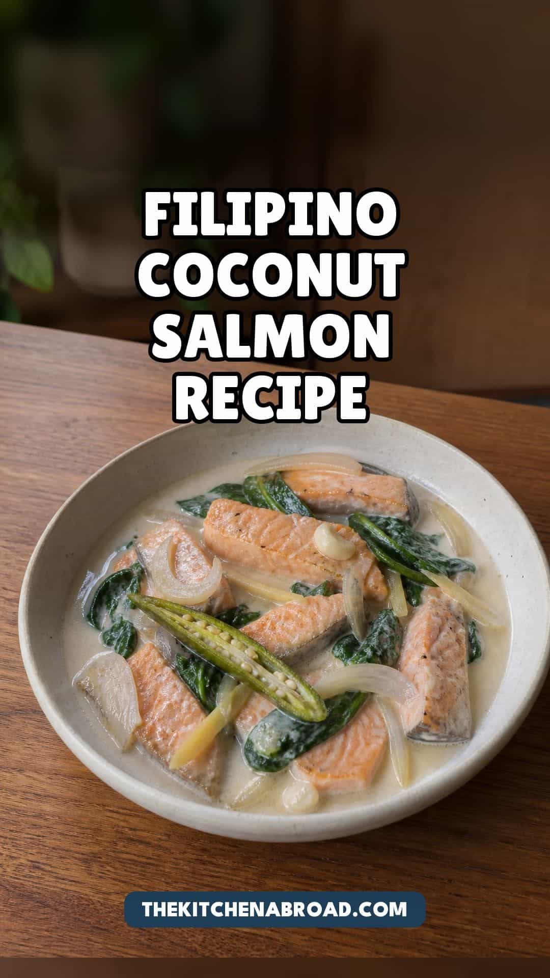 Filipino coconut salmon recipe with salmon in coconut sauce, spinach, ginger, garlic, and long green chili.