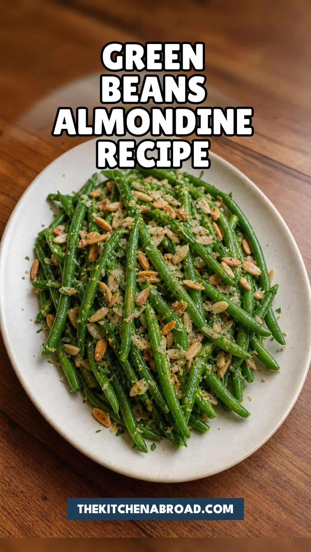 Green beans almondine recipe pin with green beans, toasted almonds, and lemon on a rustic plate.