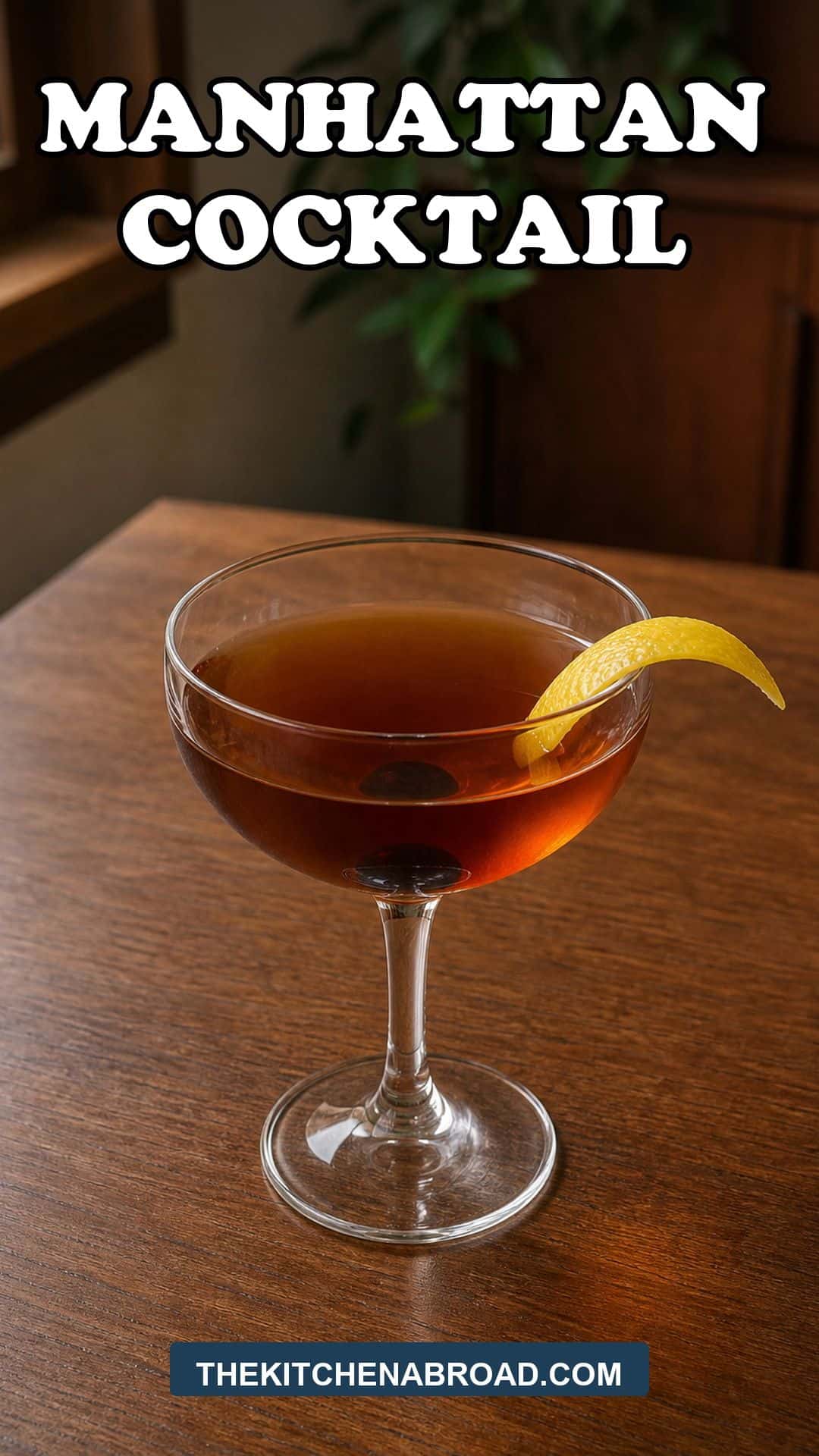 Manhattan Cocktail Recipe Manhattan cocktail in a coupe glass with a cherry and lemon twist