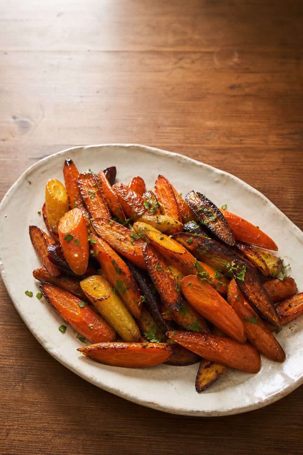 Roasted Carrots with Honey Glaze Roasted carrots with honey glaze on a ceramic platter
