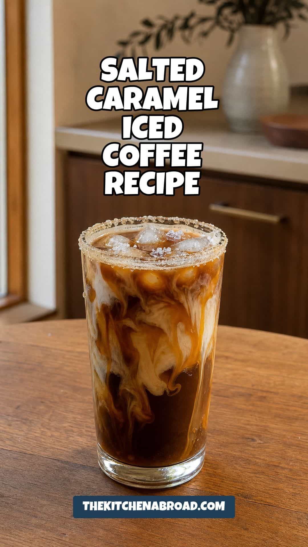 Glass of salted caramel iced coffee with milk swirling through ice