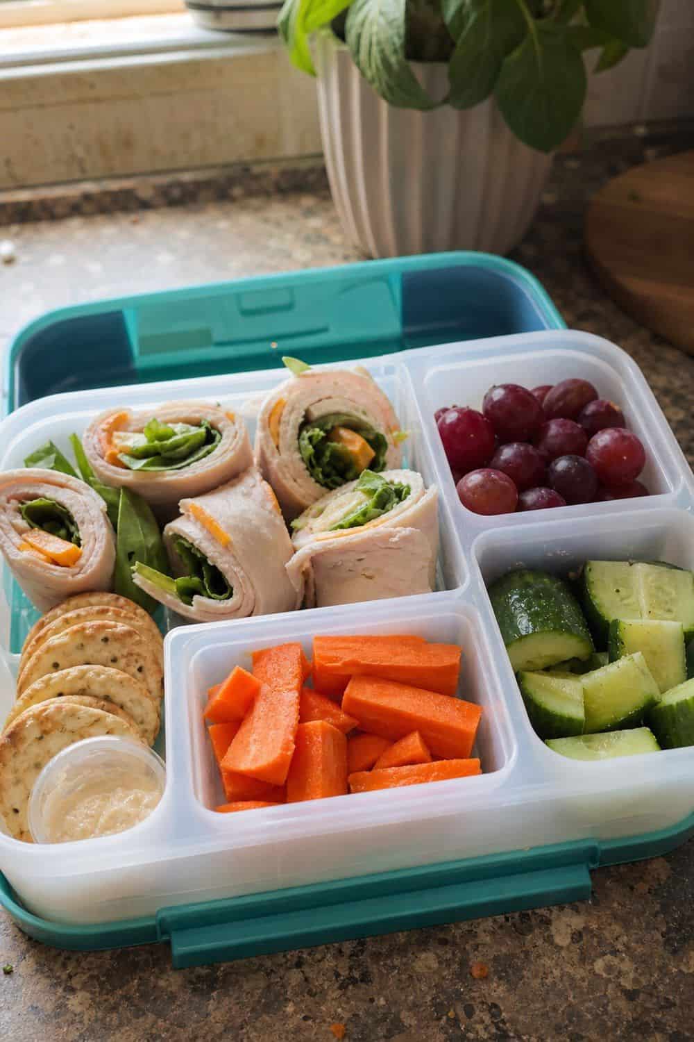20 Cold Lunch Meal Prep Ideas That Make Life Easier 9. Turkey Roll-Up Bento Lunches cold lunch meal prep idea in a packed lunch container