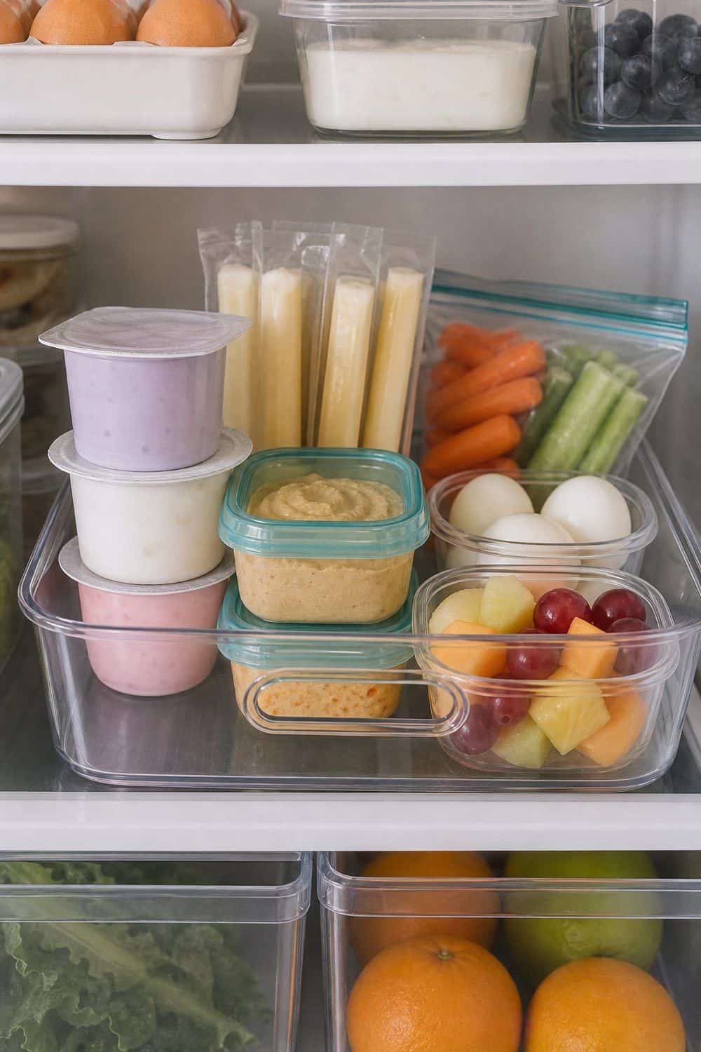 25 Fridge Organization Ideas for Less Food Waste 15. Lunchbox and Snack Zone fridge organization idea for less food waste
