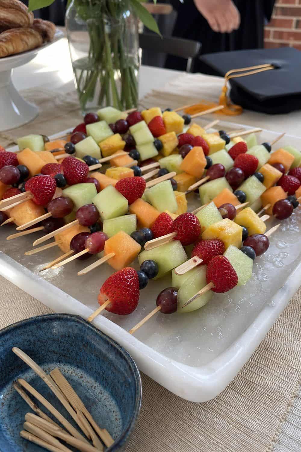 25 Graduation Brunch Hosting Ideas for an Open-House Crowd graduation brunch hosting ideas 09 serve fruit skewers instead of a loose fruit bowl