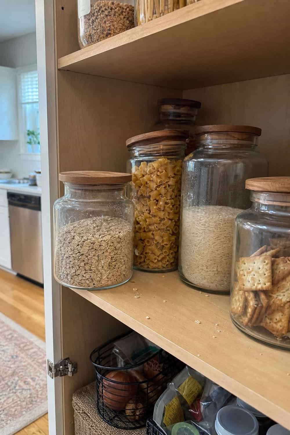 25 Best Natural Wood Kitchen Decor Finds Glass Canisters With Wood Lids for Pantry Shelves in a natural wood kitchen decor setup