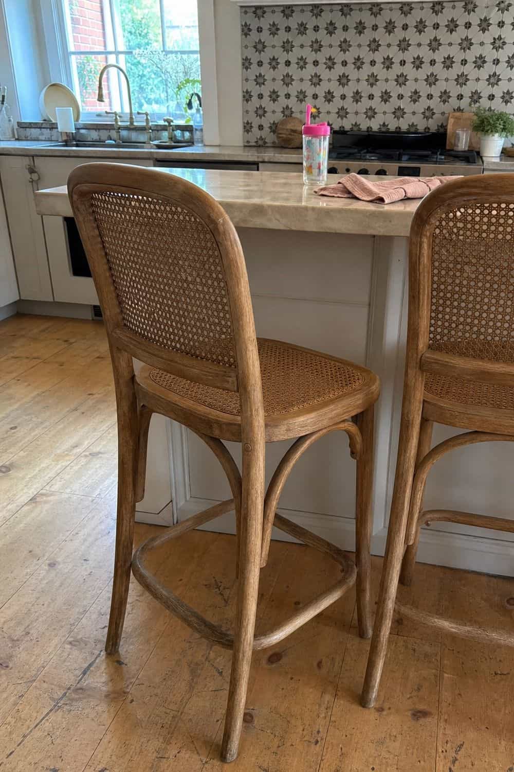 25 Best Natural Wood Kitchen Decor Finds Cane Counter Stools for Woven Wood Texture in a natural wood kitchen decor setup