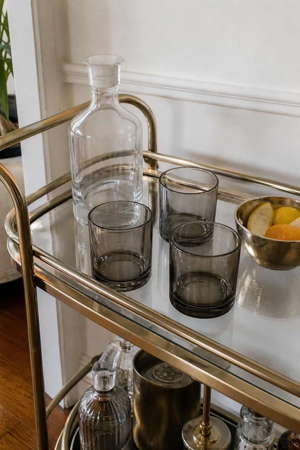 25 Neo Deco Bar Cart Ideas for Easy Hosting Smoked Glass Tumblers for the Signature Drink on a casual neo deco bar cart for easy hosting