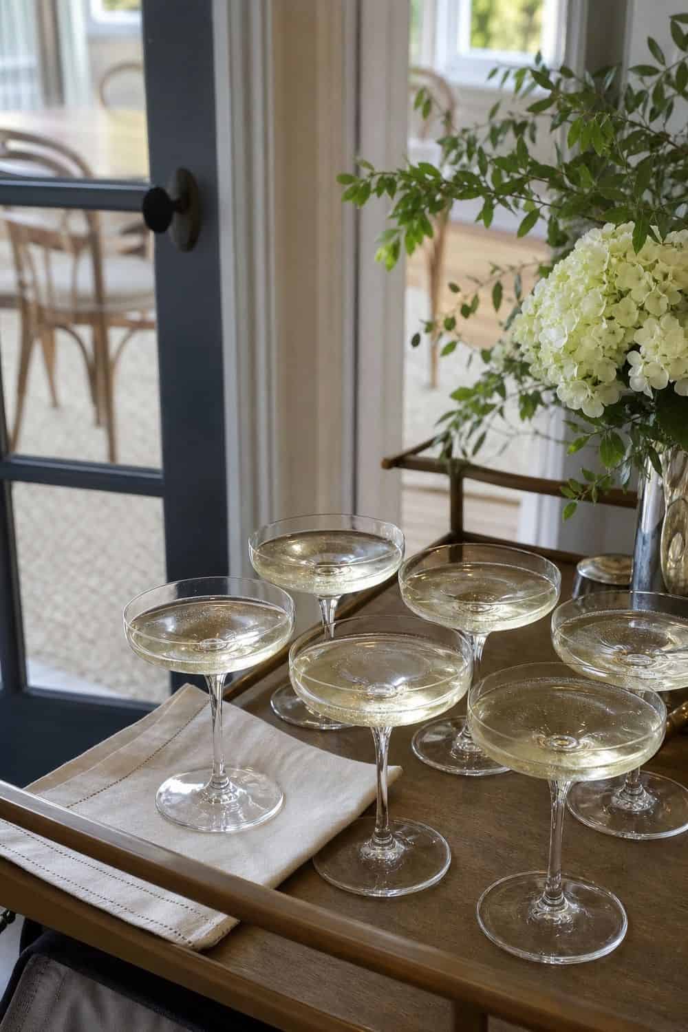 25 Neo Deco Bar Cart Ideas for Easy Hosting Coupe Glasses for a Welcome Pour on a casual neo deco bar cart for easy hosting