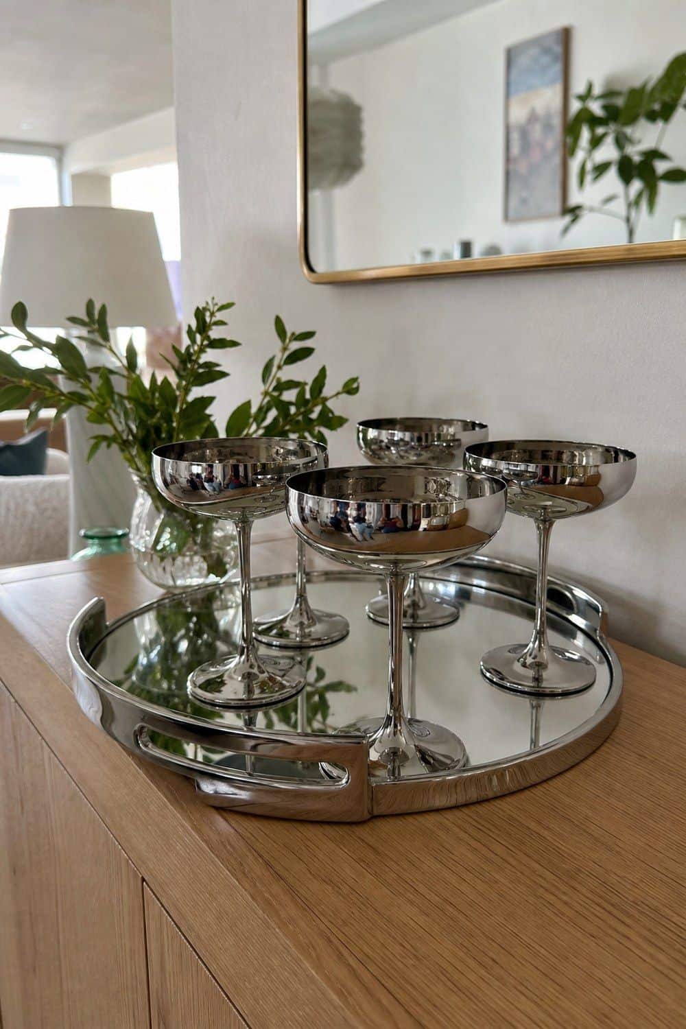 25 Neo Deco Tablescape Ideas for Easy Hosting Chrome Coupes Waiting on the Sideboard in a casual Neo Deco tablescape