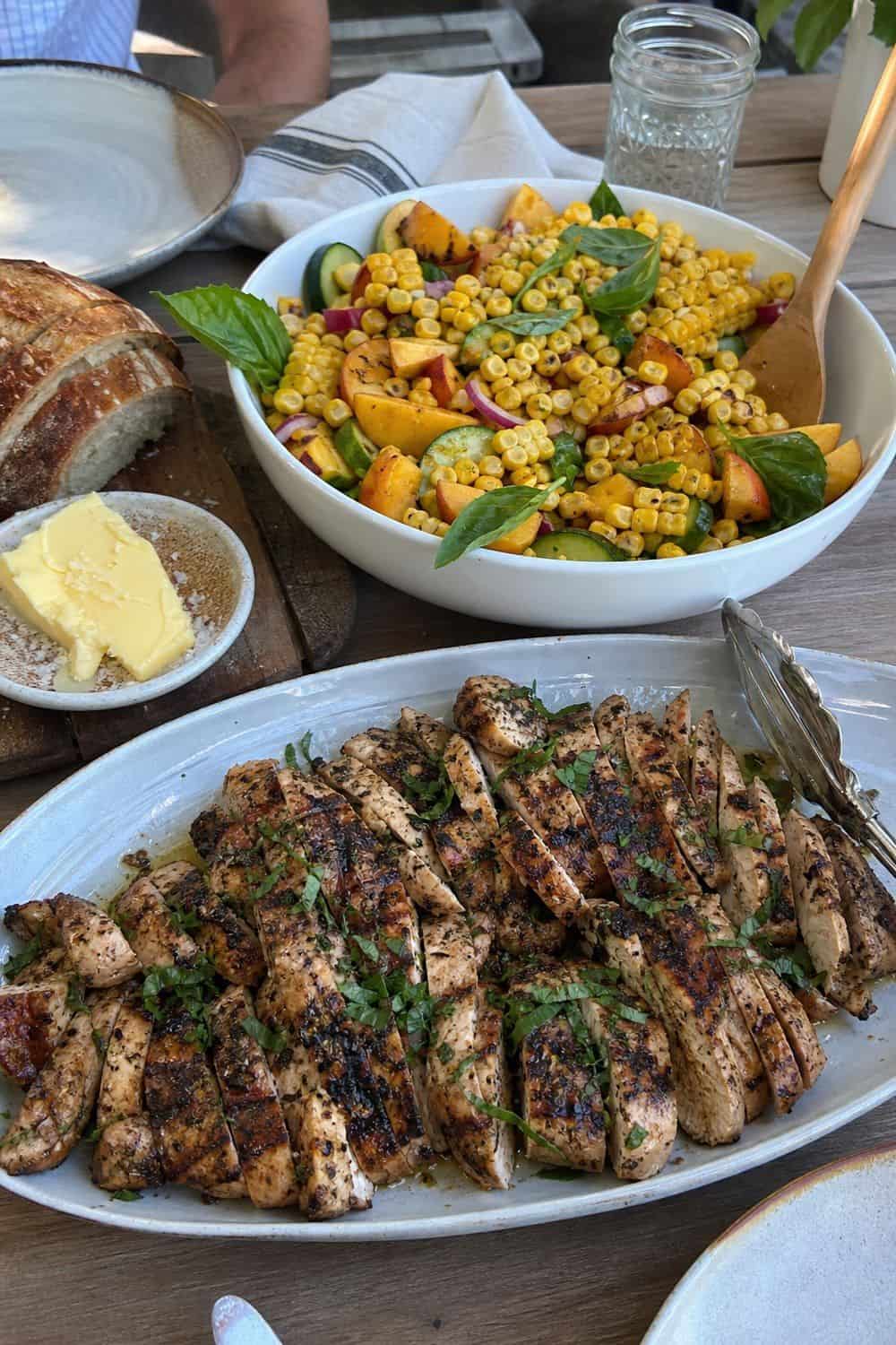 25 Summer Dinner Party Menu Ideas for Warm-Weather Hosting grilled chicken with corn and peach salad for a summer dinner party menu