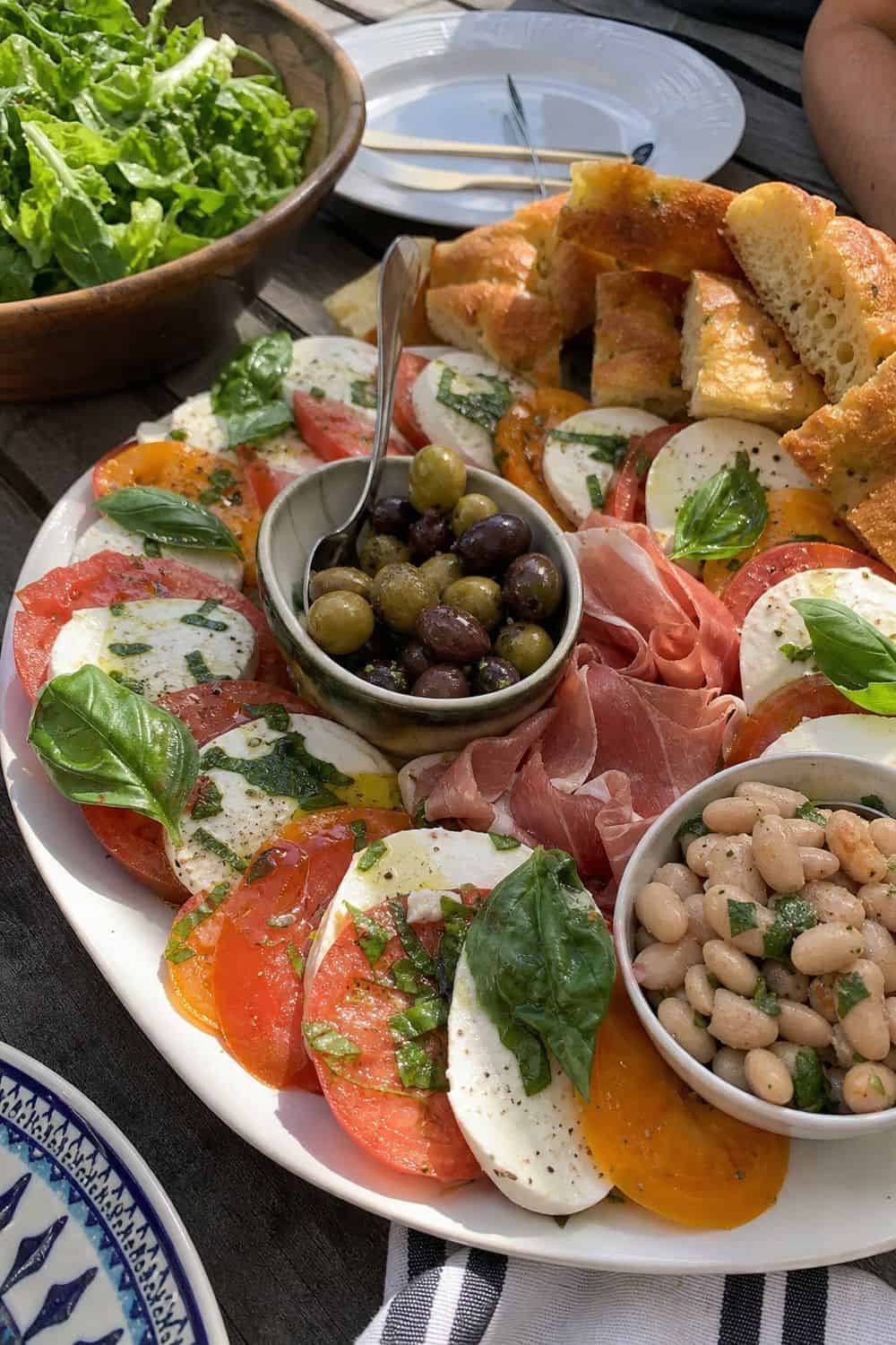 25 Summer Dinner Party Menu Ideas for Warm-Weather Hosting caprese platter with focaccia for a summer dinner party menu