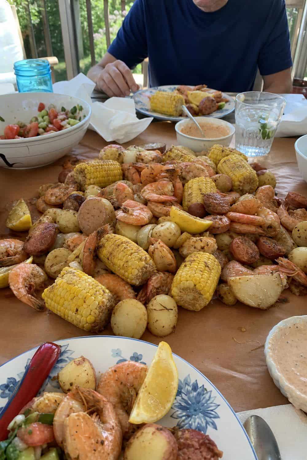 25 Summer Dinner Party Menu Ideas for Warm-Weather Hosting seafood boil-inspired table for a summer dinner party menu