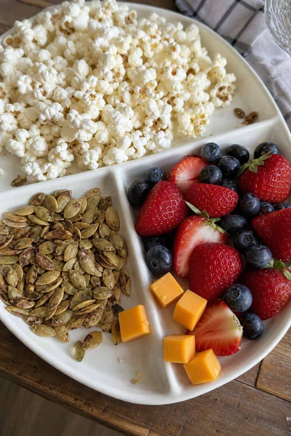 20 Summer Snack Plate Ideas for Hot Weather 9. Popcorn Pumpkin Seed Berry Plate summer snack plate