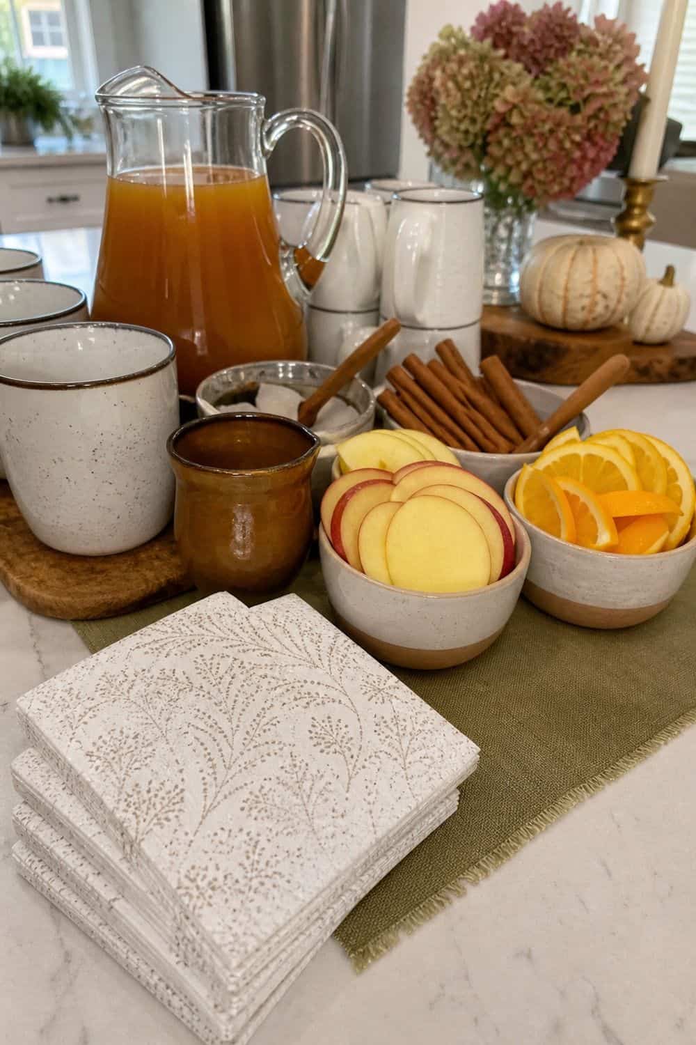 Napkins placed beside apple cider garnish bowls for guests.