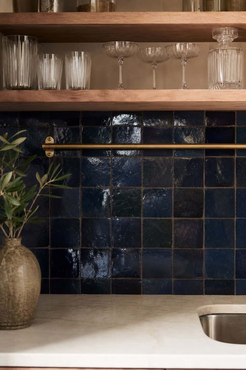 25 Blue Zellige Kitchen Ideas: Shades, Grout and Pairings Deep blue zellige tile behind a home wet bar with glassware
