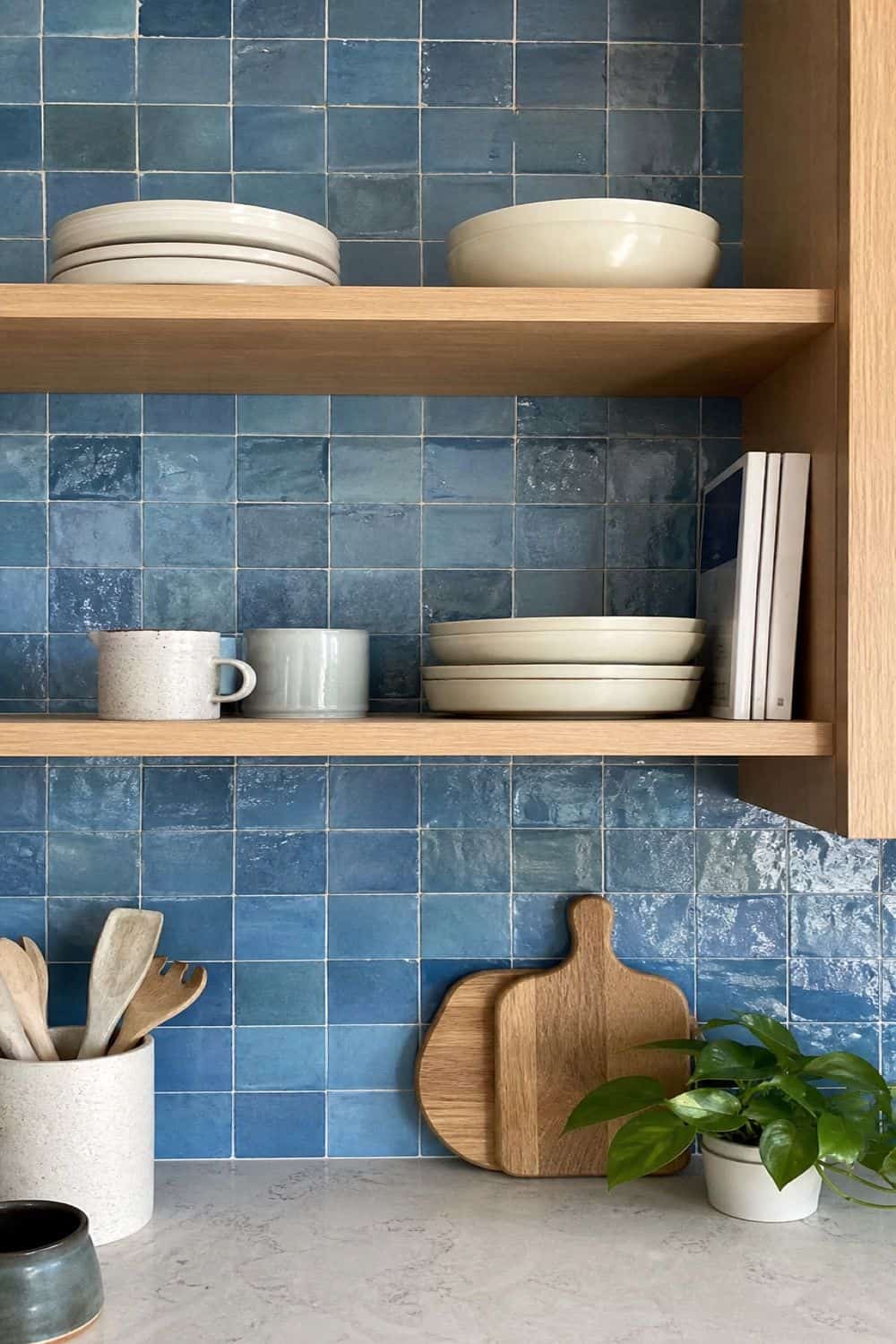 25 Blue Zellige Kitchen Ideas: Shades, Grout and Pairings Blue zellige tile lining the back of open kitchen shelves