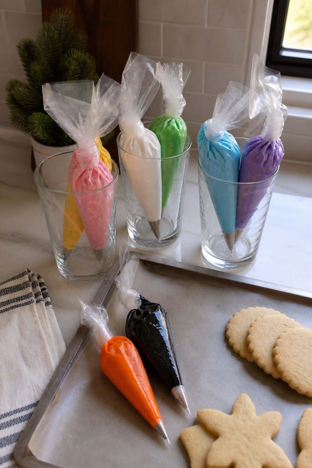 25 Christmas Cookie Decorating Party Ideas for Easy Hosting Piping Bags Filled Before the Party Starts setup for a Christmas cookie decorating party