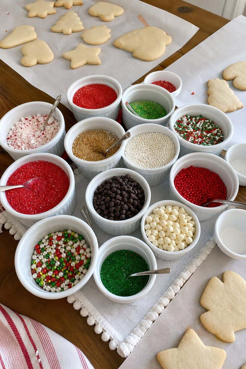 25 Christmas Cookie Decorating Party Ideas for Easy Hosting Sprinkles in Ramekins setup for a Christmas cookie decorating party