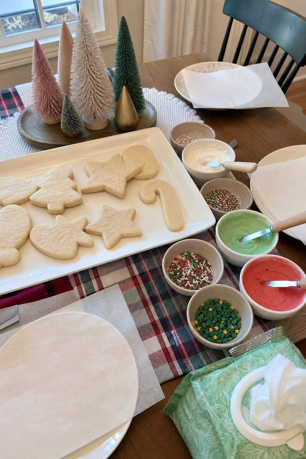 25 Christmas Cookie Decorating Party Ideas for Easy Hosting Spread-and-Sprinkle Station for Younger Kids setup for a Christmas cookie decorating party