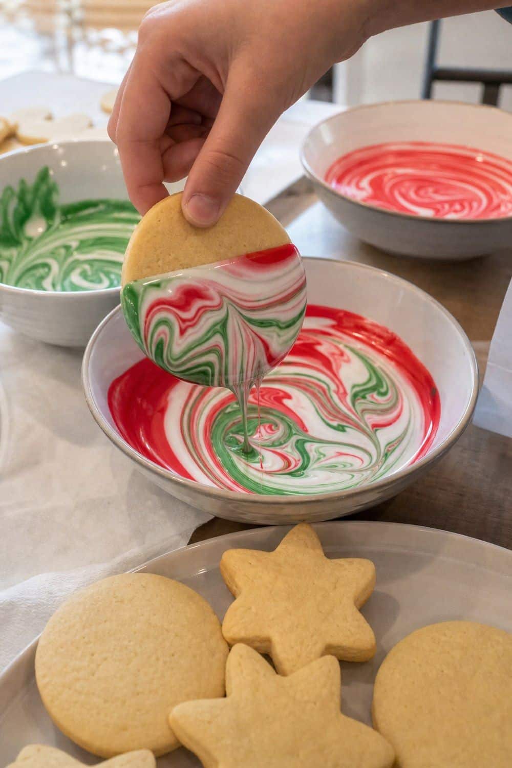 25 Christmas Cookie Decorating Party Ideas for Easy Hosting Marbled Icing for Older Kids setup for a Christmas cookie decorating party