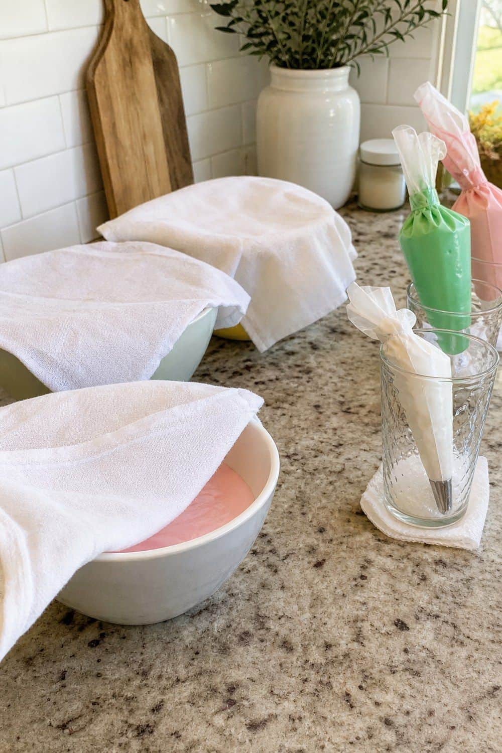 25 Christmas Cookie Decorating Party Ideas for Easy Hosting Damp Towels Over Icing Bowls setup for a Christmas cookie decorating party