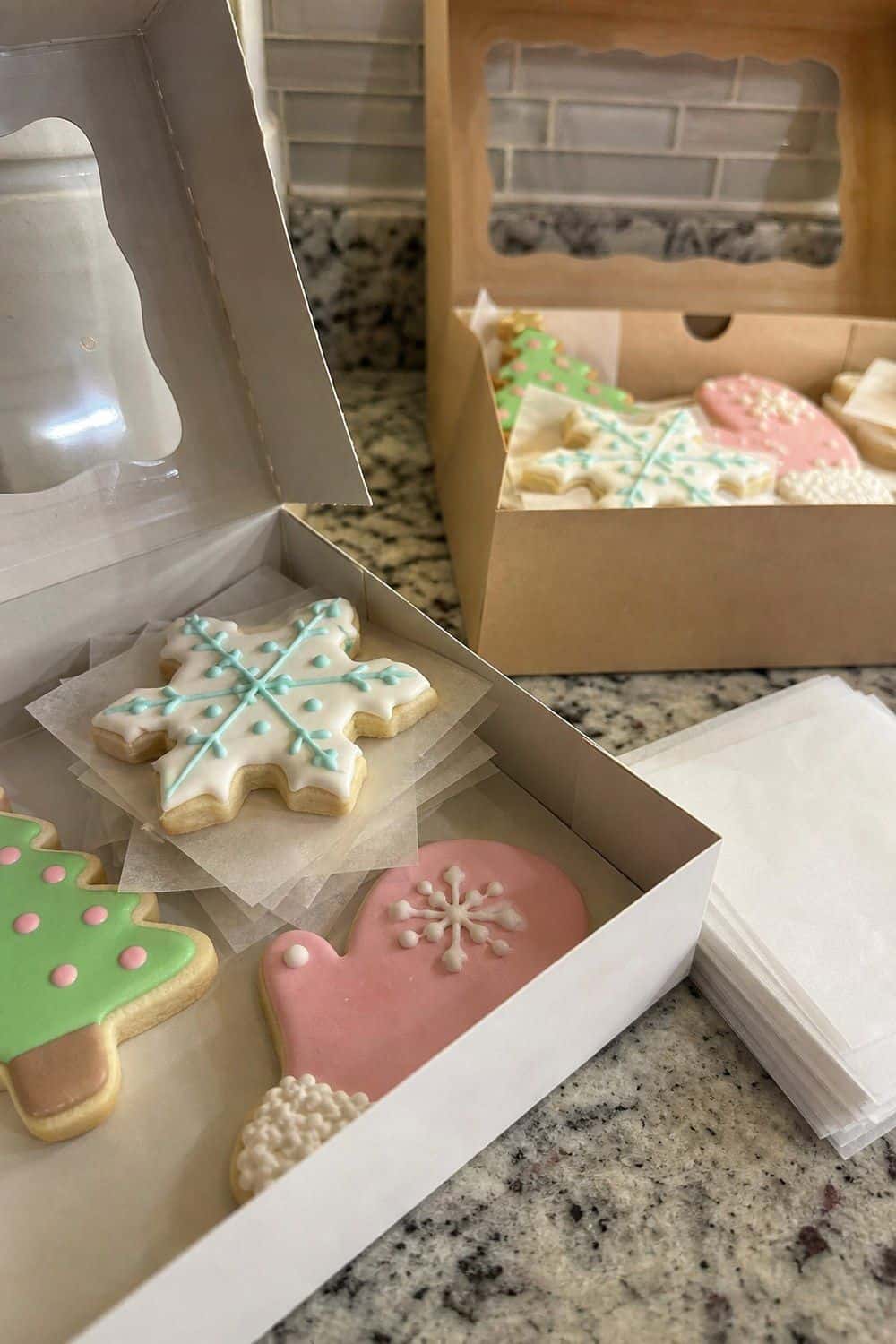 25 Christmas Cookie Decorating Party Ideas for Easy Hosting Parchment Between Cookie Layers setup for a Christmas cookie decorating party