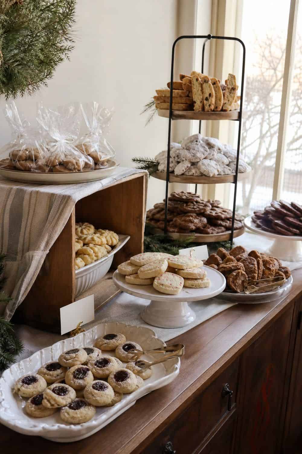 25 Christmas Cookie Party Hosting Ideas for Easy Hosting Cake Stands for High and Low Display setup for a Christmas cookie party hosting table