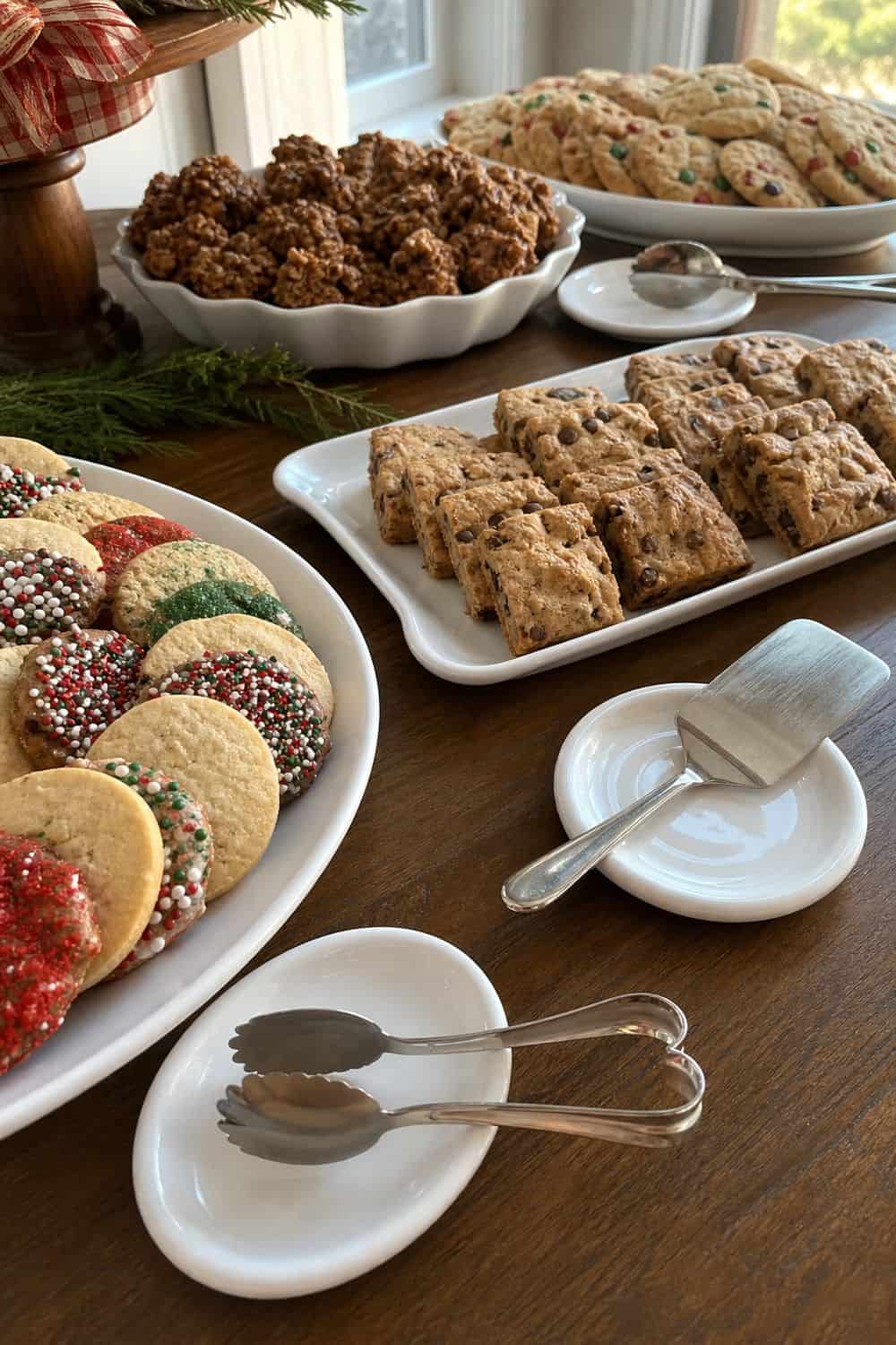 25 Christmas Cookie Party Hosting Ideas for Easy Hosting Tongs Beside Shared Platters setup for a Christmas cookie party hosting table