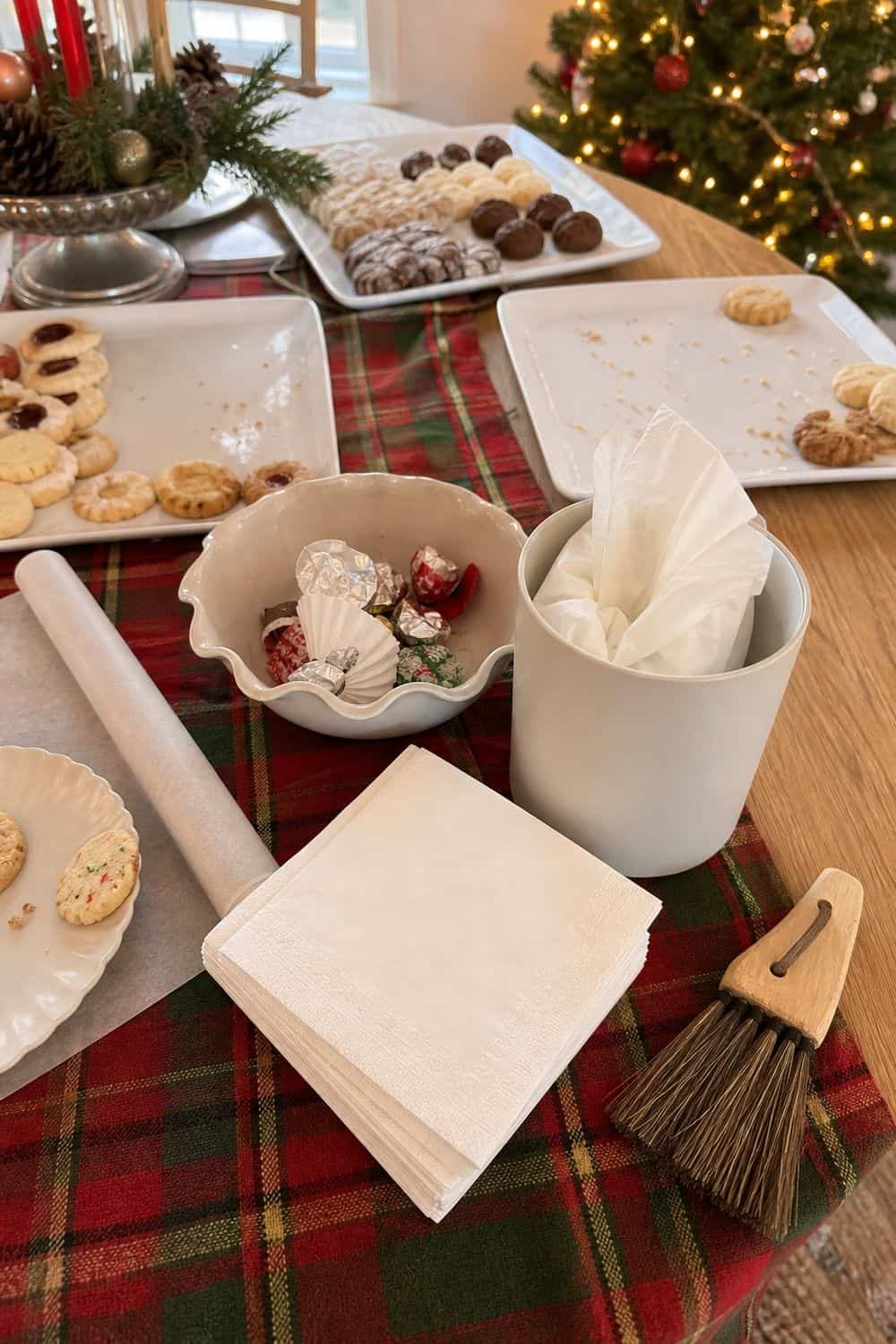25 Christmas Cookie Party Hosting Ideas for Easy Hosting Crumb Cleanup Supplies on the Table setup for a Christmas cookie party hosting table