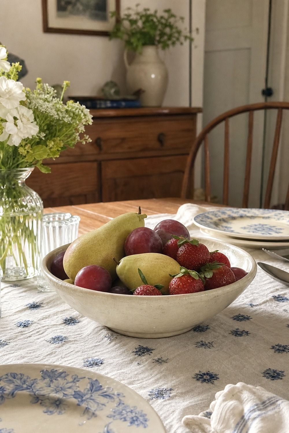 25 Cottagecore Tablescape Ideas for a Soft Floral Table 22. Low Fruit Bowl for Color cottagecore tablescape idea