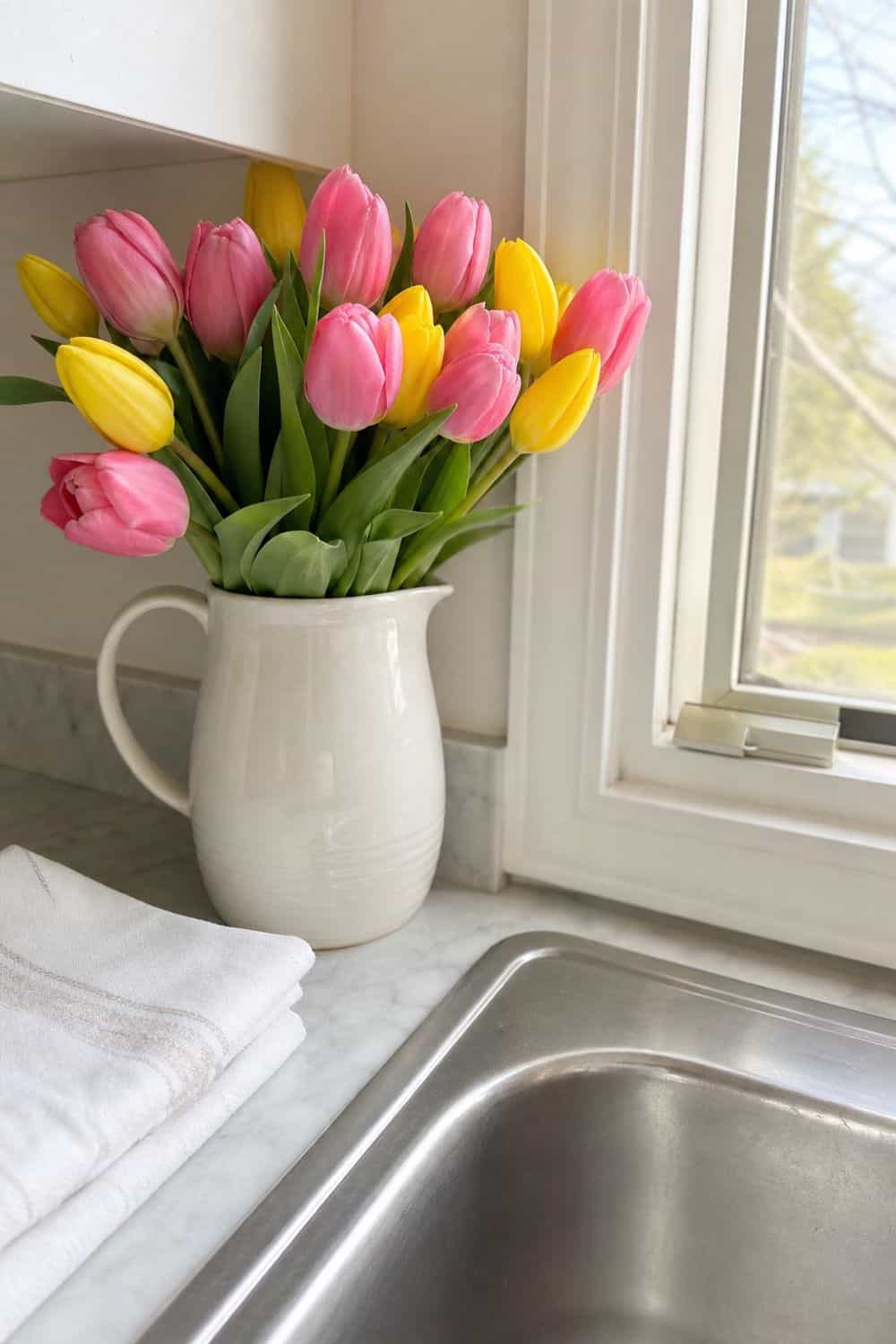 25 Easter Kitchen Decor Ideas for a Fresh Spring Touch Tulips in a Pitcher by the Sink for Easter kitchen decor
