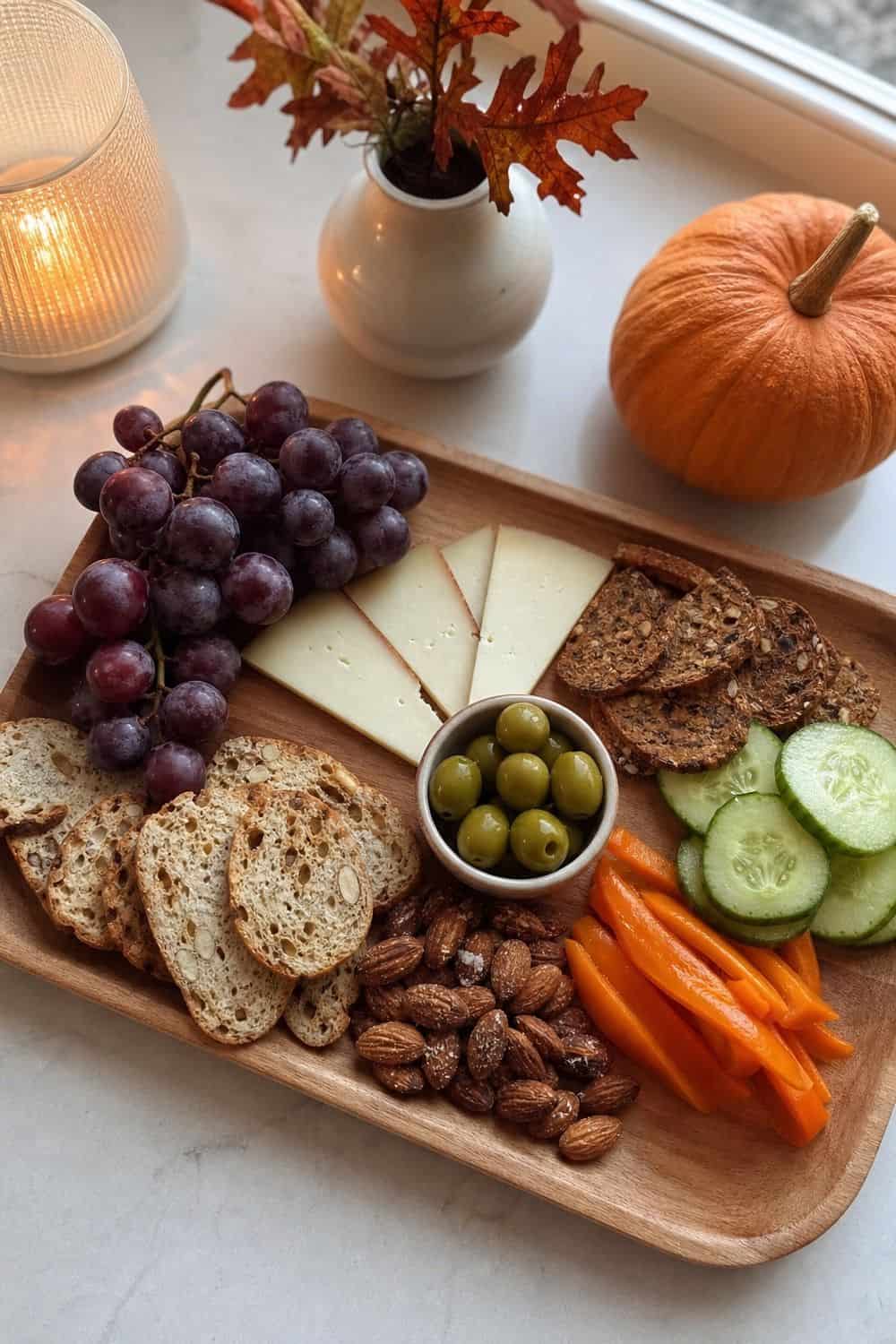 Fall dinner party idea showing set out a small appetizer board in a clean, cozy hosting setup.