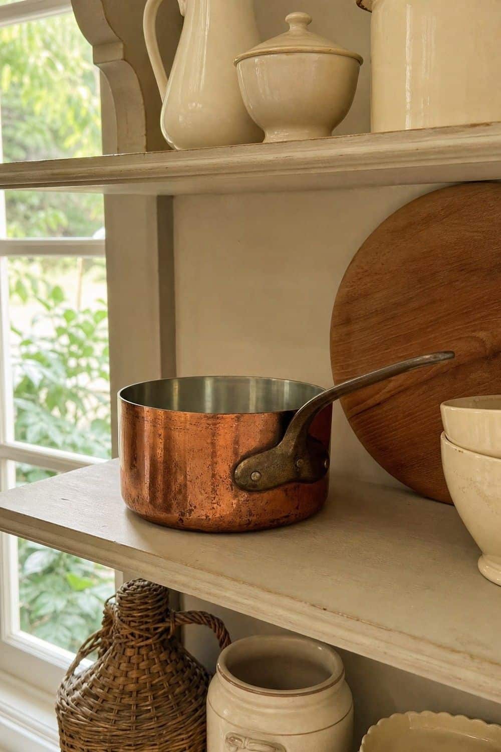25 Best French Country Kitchen Decor Finds 4. Copper Saucepan for Open-Shelf Display