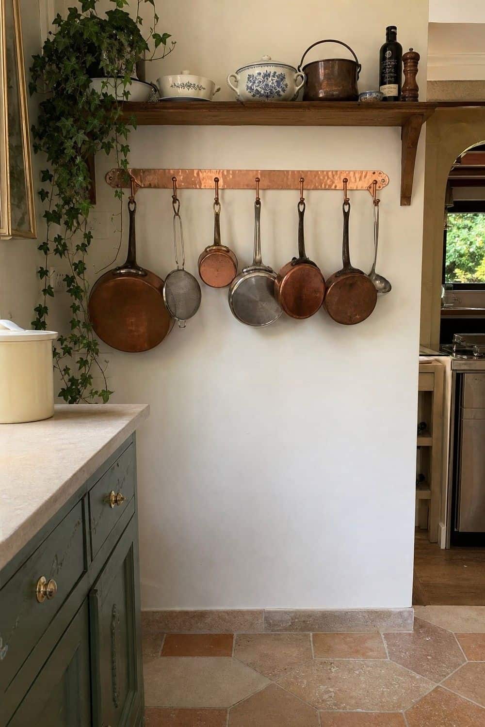 25 Best French Country Kitchen Decor Finds 5. Copper Pot Rack for a Working Kitchen Look