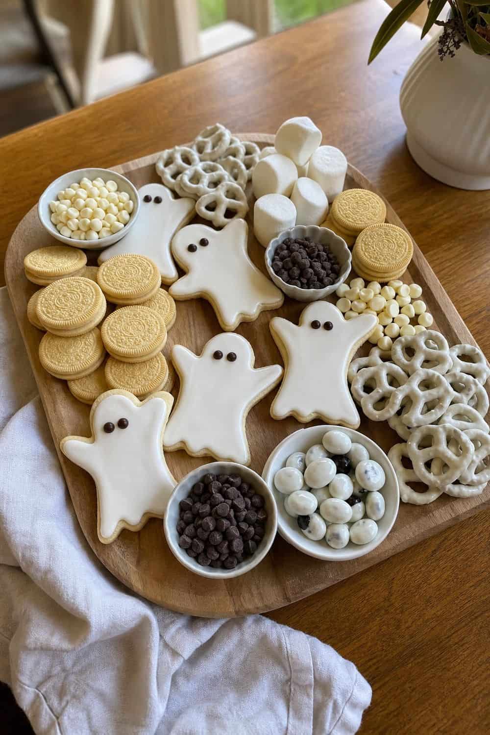 20 Halloween Treat Board Ideas for Cozy Food Moments 3. Ghost Cookie Dessert Board Halloween treat board idea arranged on a cozy home table