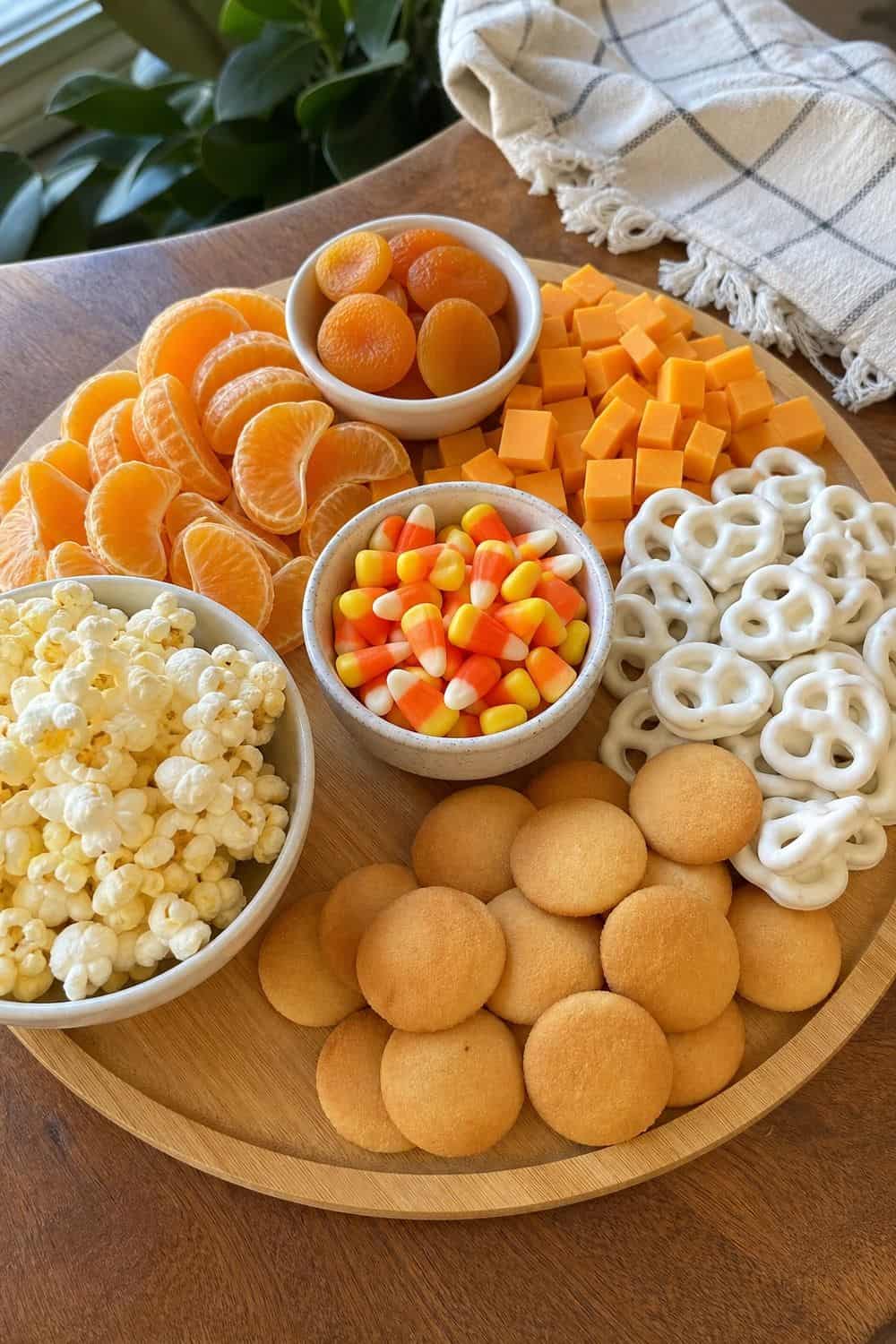 20 Halloween Treat Board Ideas for Cozy Food Moments 6. Candy Corn Color Board Halloween treat board idea arranged on a cozy home table
