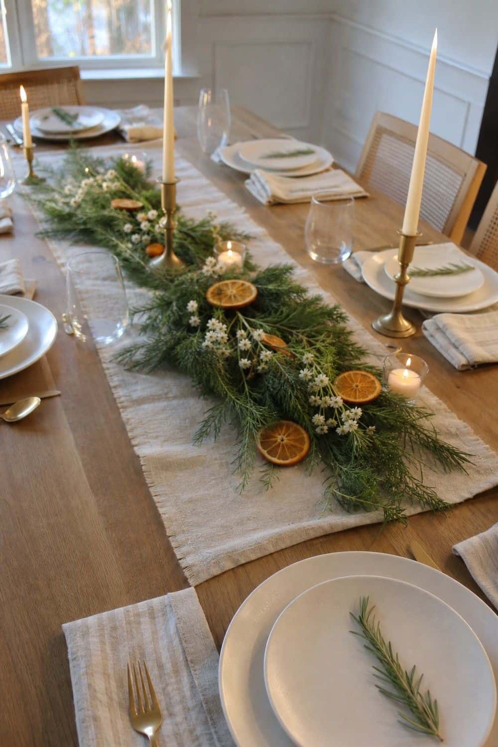 25 Holiday Dinner Party Ideas for Easy Hosting Low Greenery and Candles setup for an easy holiday dinner party.