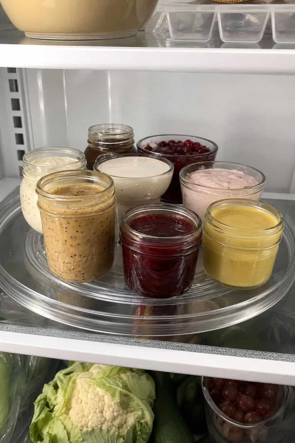 20 Holiday Fridge Ideas for Party Prep and Leftovers Holiday fridge idea showing use a turntable for dips, sauces, and condiments.
