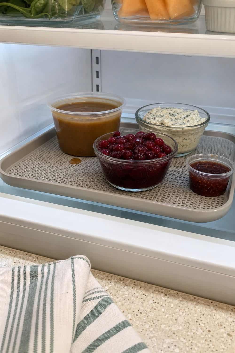 20 Holiday Fridge Ideas for Party Prep and Leftovers Holiday fridge idea showing use shelf liners or trays under messy foods.
