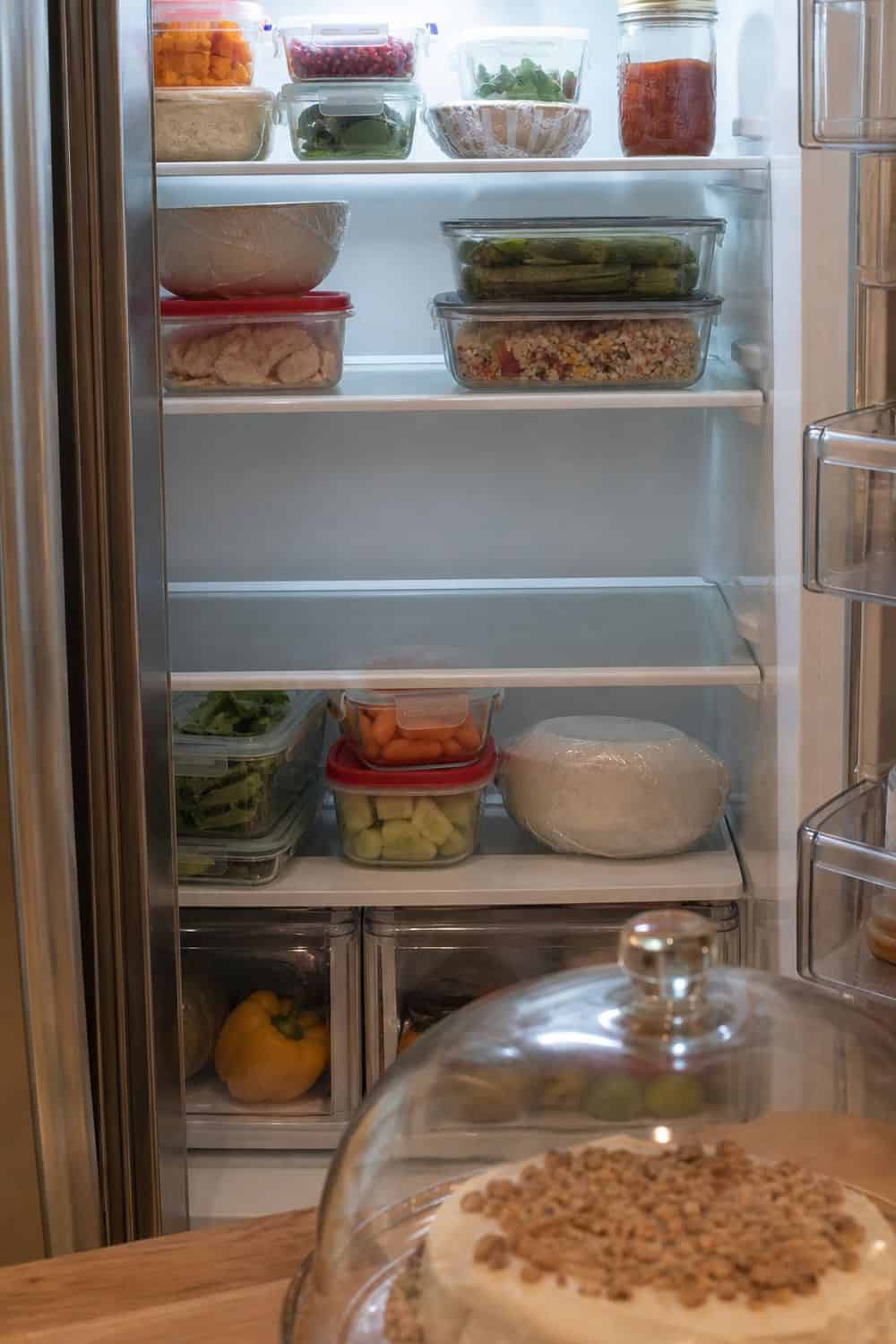 20 Holiday Fridge Ideas for Party Prep and Leftovers Holiday fridge idea showing leave one open shelf for last-minute party food.