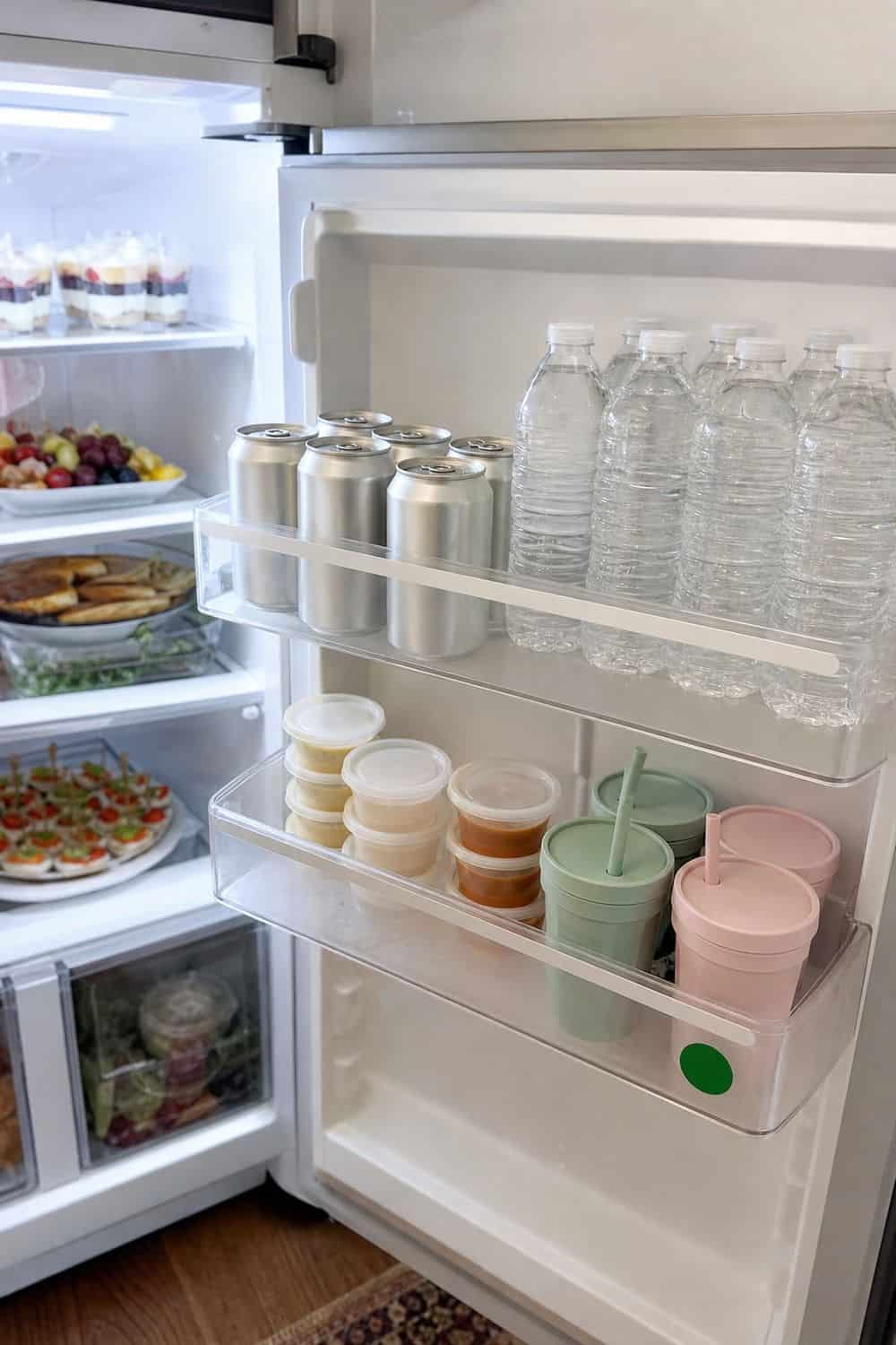 20 Holiday Fridge Ideas for Party Prep and Leftovers Holiday fridge idea showing make a door zone for guest-friendly items.
