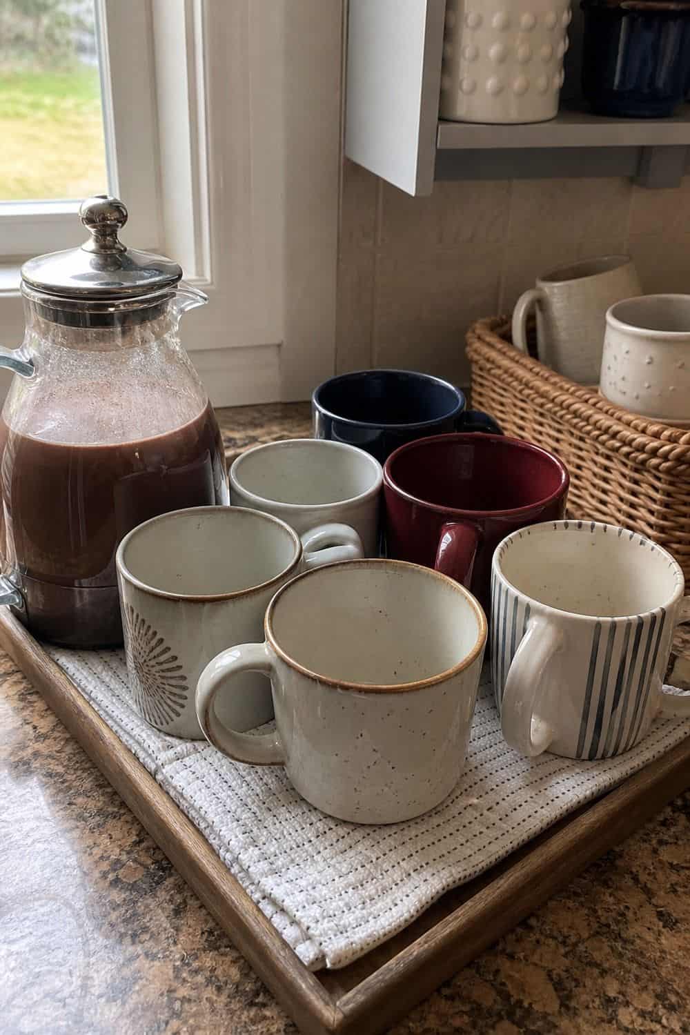 20 Hot Chocolate Station Ideas for Cozy Winter Nights mugs together on a rack or tray setup for a cozy hot chocolate station with practical serving details.