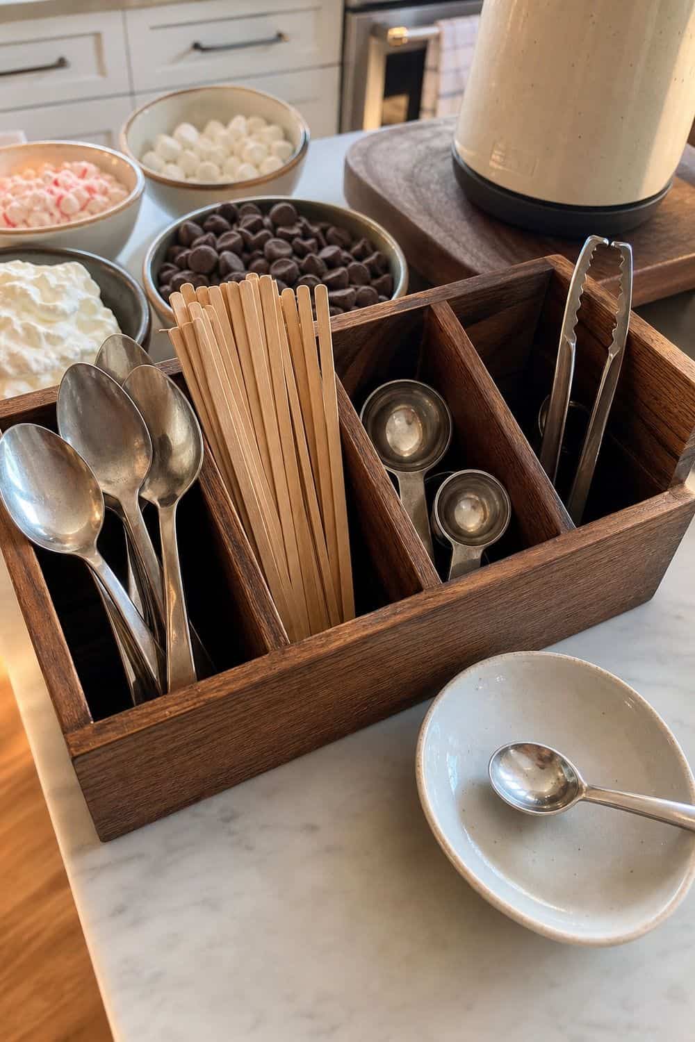20 Hot Chocolate Station Ideas for Cozy Winter Nights one caddy for spoons, stirrers, and scoops setup for a cozy hot chocolate station with practical serving details.