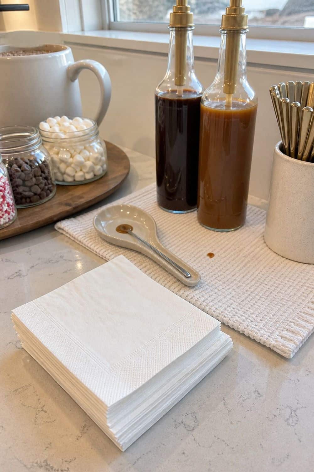 20 Hot Chocolate Station Ideas for Cozy Winter Nights napkins and a drip mat setup for a cozy hot chocolate station with practical serving details.