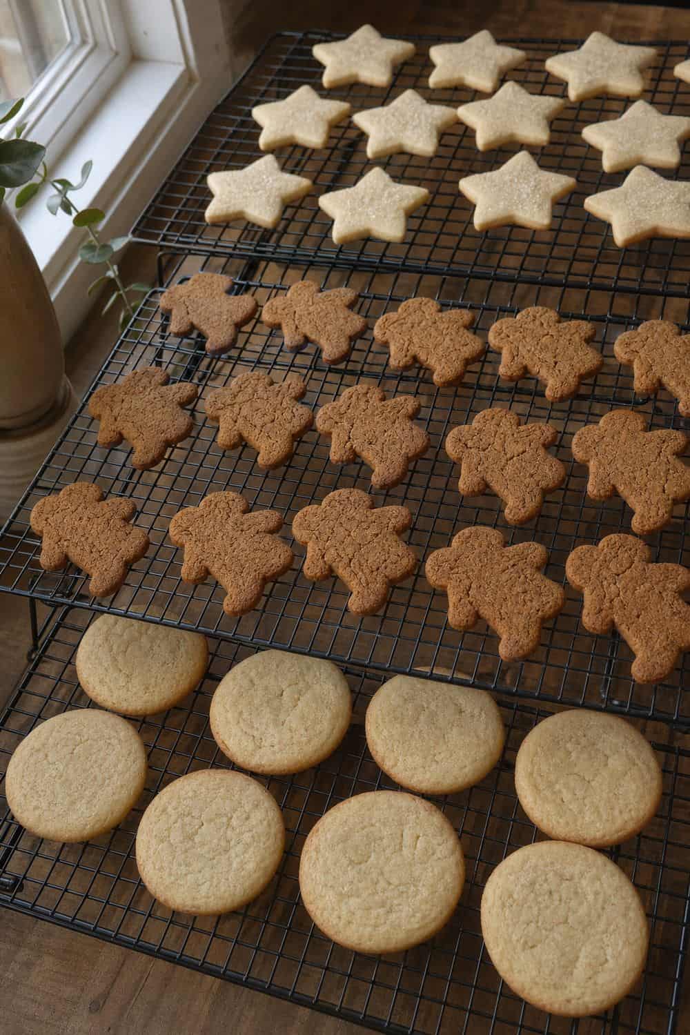 How to Store Holiday Cookies So They Stay Fresh Cooling racks filled with fully baked holiday cookies before storage.