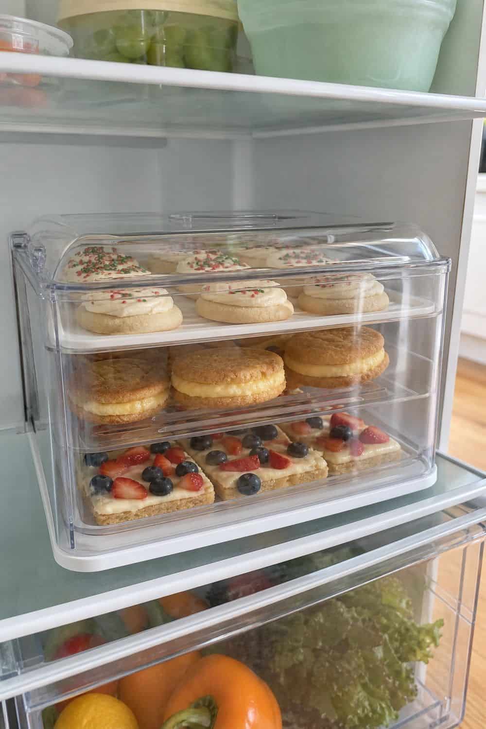 How to Store Holiday Cookies So They Stay Fresh Perishable filled holiday cookies stored in a covered refrigerator dessert container.